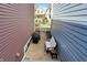 Backyard view between homes featuring patio seating, a grill, and a decorative fountain at 2037 Rhettsbury St, Carmel, IN 46032
