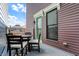 Balcony area featuring an outdoor dining set and a view of neighboring homes and the blue sky at 2037 Rhettsbury St, Carmel, IN 46032