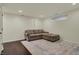 Comfortable basement with dark floors, a large sectional sofa, and a stylish area rug at 2037 Rhettsbury St, Carmel, IN 46032