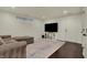 Finished basement with a TV, storage and a cozy sectional sofa at 2037 Rhettsbury St, Carmel, IN 46032