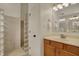 Bathroom featuring a sink vanity, mirror with lighting, and modern glass block shower at 2037 Rhettsbury St, Carmel, IN 46032