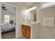 Bathroom showcasing a sink vanity, large mirror with lighting, and view to the bedroom at 2037 Rhettsbury St, Carmel, IN 46032