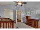 Bedroom with a crib, dresser, adjacent bathroom and double door closet at 2037 Rhettsbury St, Carmel, IN 46032