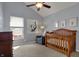 Bedroom featuring a wooden crib, dresser, sitting chair and a window at 2037 Rhettsbury St, Carmel, IN 46032