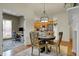 Dining area with hardwood floors, modern lighting, and adjacent office and kitchen spaces at 2037 Rhettsbury St, Carmel, IN 46032