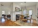 Cozy dining room featuring a fireplace, modern lighting, and hardwood flooring at 2037 Rhettsbury St, Carmel, IN 46032