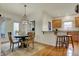 Dining area with hardwood floors, stylish lighting, and an eat-in kitchen bar at 2037 Rhettsbury St, Carmel, IN 46032