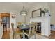 Charming dining area with a fireplace, stylish lighting, and stainless steel appliances nearby at 2037 Rhettsbury St, Carmel, IN 46032