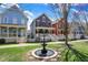 Beautiful fountain accents the front of colorful homes with inviting porches at 2037 Rhettsbury St, Carmel, IN 46032