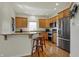 Modern kitchen featuring stainless steel appliances, granite countertops, and hardwood floors at 2037 Rhettsbury St, Carmel, IN 46032