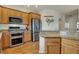 Well-equipped kitchen features stainless steel appliances and granite countertops at 2037 Rhettsbury St, Carmel, IN 46032