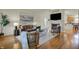 Open living room with hardwood floors, a fireplace, and a view of the kitchen at 2037 Rhettsbury St, Carmel, IN 46032