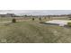 Expansive backyard featuring a concrete patio, young trees, and ample space for outdoor activities and landscaping possibilities at 2145 W Bedrock Ln, Greenfield, IN 46140