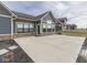 Backyard patio of a home featuring durable concrete, a well manicured lawn, and an exterior of blue siding and brick at 2145 W Bedrock Ln, Greenfield, IN 46140