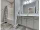 Modern bathroom featuring a shower-tub combination and sleek gray cabinets at 2145 W Bedrock Ln, Greenfield, IN 46140