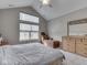 Bedroom with vaulted ceilings features a chaise lounge, wooden dresser, plush carpet, and a queen bed at 2145 W Bedrock Ln, Greenfield, IN 46140