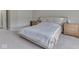 Bright bedroom featuring plush carpeting, neutral walls, a white linen bed, and side tables on either side of the bed at 2145 W Bedrock Ln, Greenfield, IN 46140