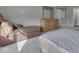 A bedroom with neutral walls features a lounge chair and a dresser near a bed with white linen at 2145 W Bedrock Ln, Greenfield, IN 46140