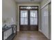 Elegant entryway featuring a wooden double door, hardwood floors, and stylish console table at 2145 W Bedrock Ln, Greenfield, IN 46140