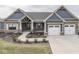 Charming craftsman style home with brick and siding, featuring a three-car garage and professionally landscaped yard at 2145 W Bedrock Ln, Greenfield, IN 46140