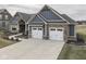 Exterior shot of a home with a spacious three-car garage and a well-manicured front yard at 2145 W Bedrock Ln, Greenfield, IN 46140