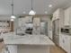 Bright, open kitchen with a large island, granite countertops, and modern appliances at 2145 W Bedrock Ln, Greenfield, IN 46140
