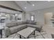 Open-concept living room with a large sectional sofa, modern coffee table, and view into the kitchen at 2145 W Bedrock Ln, Greenfield, IN 46140
