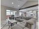 Open-concept living space with a sectional sofa, marble-top coffee table, and seamless flow into the kitchen at 2145 W Bedrock Ln, Greenfield, IN 46140