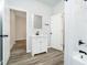 Well-lit bathroom featuring sleek vanity with a white sink and a large mirror at 242 N Tacoma Ave, Indianapolis, IN 46201