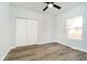 Neutral bedroom with wood-look flooring, a closet, and natural light at 242 N Tacoma Ave, Indianapolis, IN 46201