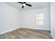 Neutral bedroom with hardwood floors, a ceiling fan, and natural light at 242 N Tacoma Ave, Indianapolis, IN 46201