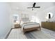 Bright bedroom featuring two windows, a ceiling fan, and neutral decor at 242 N Tacoma Ave, Indianapolis, IN 46201