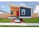 Modern home featuring a unique angular roof, wood and navy siding, and a bright red front door at 242 N Tacoma Ave, Indianapolis, IN 46201