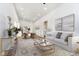 Bright living room featuring light wood floors, white walls, and a white sofa at 242 N Tacoma Ave, Indianapolis, IN 46201