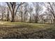 The backyard features a well-maintained lawn, mature trees, and a sense of tranquility at 2835 S Lyons Ave, Indianapolis, IN 46241
