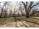 A spacious backyard with a lush lawn, offering ample outdoor space and mature trees, perfect for Gathering gatherings at 2835 S Lyons Ave, Indianapolis, IN 46241