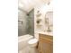 This bathroom boasts a tiled shower and bathtub, accompanied by an elegant mirror and a stylish wooden sink at 2835 S Lyons Ave, Indianapolis, IN 46241