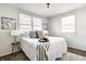 This cozy bedroom is illuminated by natural light coming through the windows and decorated with lamps and wall art at 2835 S Lyons Ave, Indianapolis, IN 46241