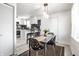 Dining area with modern table, chairs and lighting that connects to an open kitchen at 2835 S Lyons Ave, Indianapolis, IN 46241