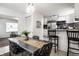 Bright dining room features modern table with seating, stylish decor, and an open flow to the updated kitchen at 2835 S Lyons Ave, Indianapolis, IN 46241
