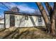 This home's exterior features neutral siding, black trim, and a dark front door, presenting a clean and modern look at 2835 S Lyons Ave, Indianapolis, IN 46241
