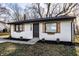 Charming home with white siding, wood shutters, manicured lawn, and fresh landscaping at 2835 S Lyons Ave, Indianapolis, IN 46241