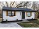 Charming home with white siding, wood shutters, manicured lawn, and fresh landscaping at 2835 S Lyons Ave, Indianapolis, IN 46241