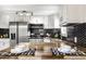 Modern kitchen features stainless steel appliances, butcher block countertops, and black honeycomb backsplash at 2835 S Lyons Ave, Indianapolis, IN 46241