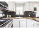 Updated kitchen showcasing stainless steel appliances, black honeycomb backsplash, and butcher block countertops at 2835 S Lyons Ave, Indianapolis, IN 46241