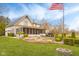 Charming backyard featuring a manicured lawn, lush landscaping, and a flag pole at 3849 Waycross Dr, Columbus, IN 47203