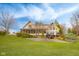Beautiful backyard with a well-maintained lawn, retaining wall, and mature trees at 3849 Waycross Dr, Columbus, IN 47203
