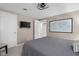 This bedroom features a queen bed, ceiling light fixture, and a modern wall-mounted television at 3849 Waycross Dr, Columbus, IN 47203