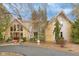 Beautiful home with stone and siding exterior, a red front door, and mature landscaping at 3849 Waycross Dr, Columbus, IN 47203