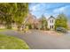 Stunning home with a circular driveway, beautiful trees, and manicured landscaping at 3849 Waycross Dr, Columbus, IN 47203